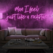 hot pink man i feel just like a rockstar neon sign hanging on living room wall