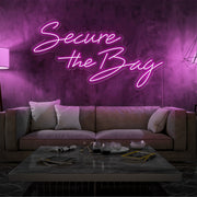 hot pink secure the bag neon sign hanging on living room wall
