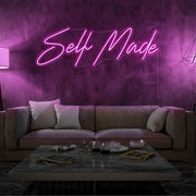 hot pink self made neon sign hanging on living room wall
