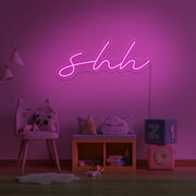 hot pink shh neon sign hanging on kids bedroom wall