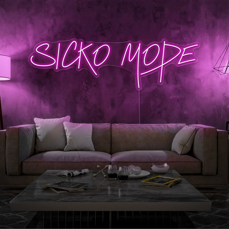 hot pink sicko mode neon sign hanging on living room wall