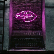 hot pink smoking lips neon sign hanging on bar wall