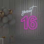 hot pink sweet 16 neon sign hanging on wall