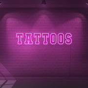 hot pink tattoos neon sign hanging on wall