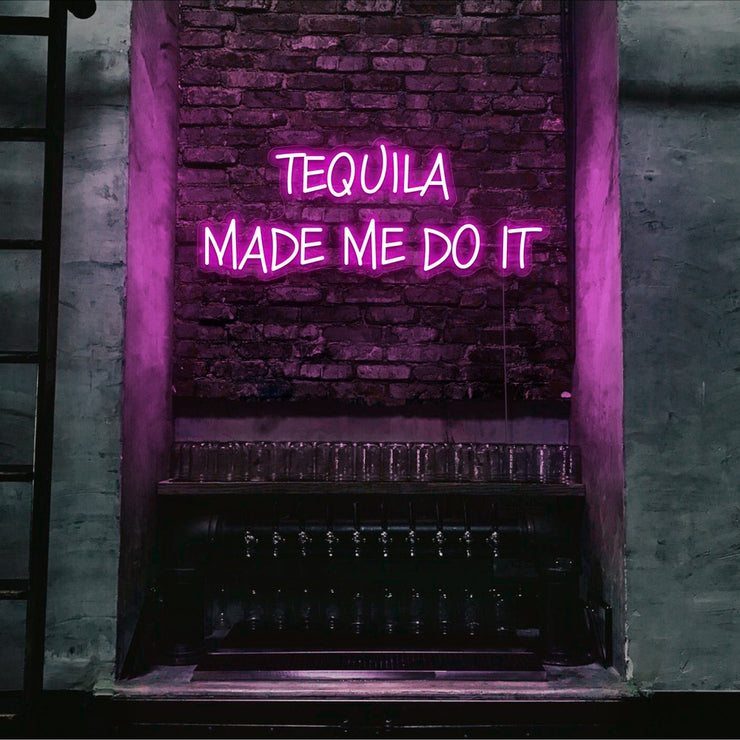hot pink tequila made me do it neon sign hanging on bar wall