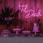 hot pink til death neon sign hanging on timber wall above dessert table