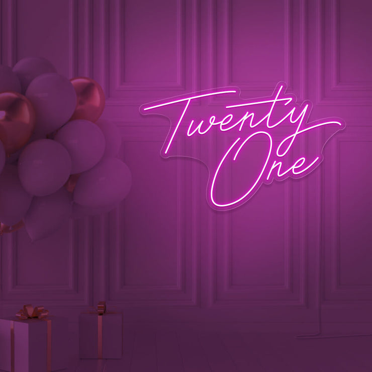 hot pink  twenty one neon sign hanging on wall with balloons