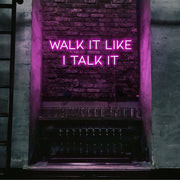 hot pink walk it like i talk it neon sign hanging on bar wall