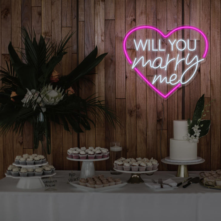 hot pink will you marry me heart neon sign hanging on timber wall above dessert table
