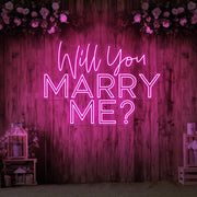 hot pink will you marry me neon sign hanging on timber wall