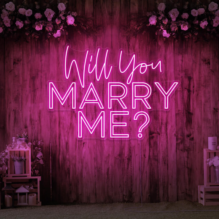 hot pink will you marry me neon sign hanging on timber wall