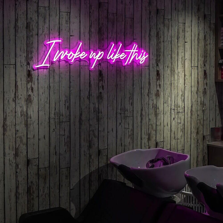 pink I woke up like this beauty neon sign hanging on hair salon wall
