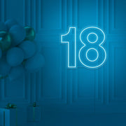 ice blue 18 neon sign hanging on wall with balloons