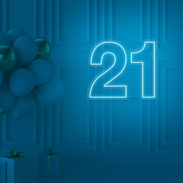 ice blue  21 neon sign hanging on wall with balloons