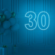 ice blue 30 neon sign hanging on wall with balloons