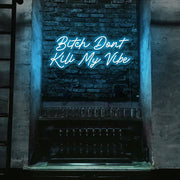 ice blue bitch don't kill my vibe neon sign hanging on bar wall