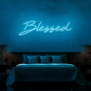 ice blue blessed neon sign hanging on bedroom wall