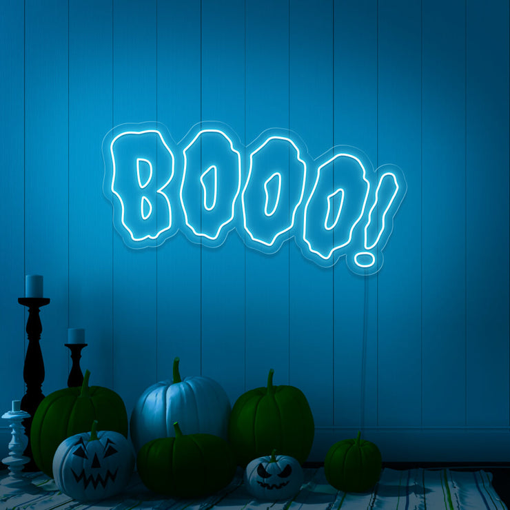 ice blue boo neon sign with halloween pumpkins on floor