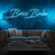ice blue boss babe neon sign hanging on living room wall