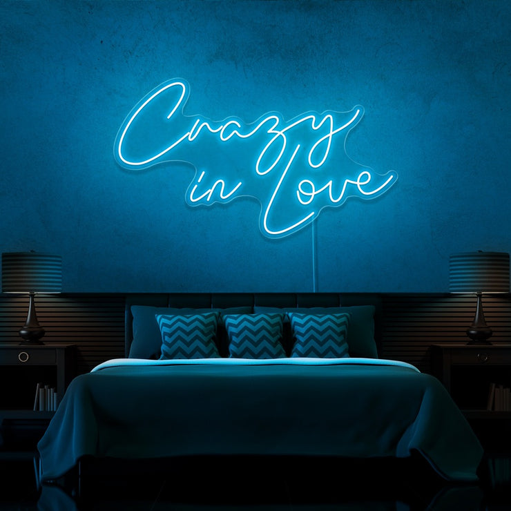 ice blue in love neon sign hanging on bedroom wall