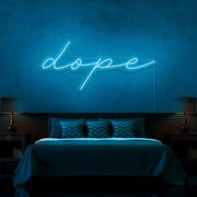 ice blue dope cursive neon sign hanging on bedroom wall