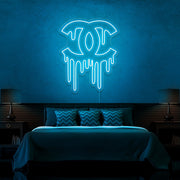 ice blue dripping chanel neon sign hanging on bedroom wall