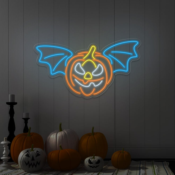 ice blue flying pumpkin neon sign hanging on wall above pumpkins