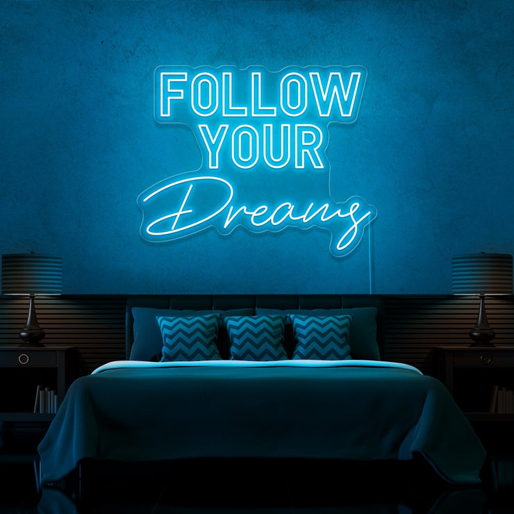 ice blue follow your dreams neon sign hanging on bedroom wall
