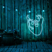ice blue ghost neon sign hanging on timber wall