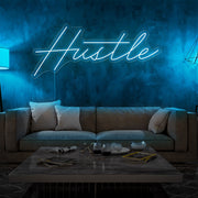 ice blue hustle neon sign hanging on living room wall