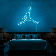 ice blue jordan jumpman neon sign hanging on bedroom wall