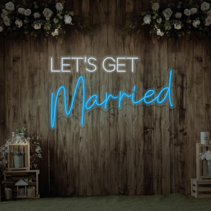 ice blue lets get married neon sign hanging on timber wall
