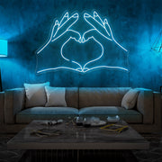 ice blue love hands neon sign hanging on living room wall