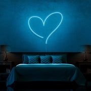 ice blue love heart neon sign hanging on bedroom wall