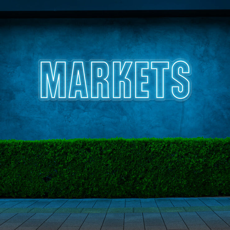 ice blue markets neon sign hanging on outside wall