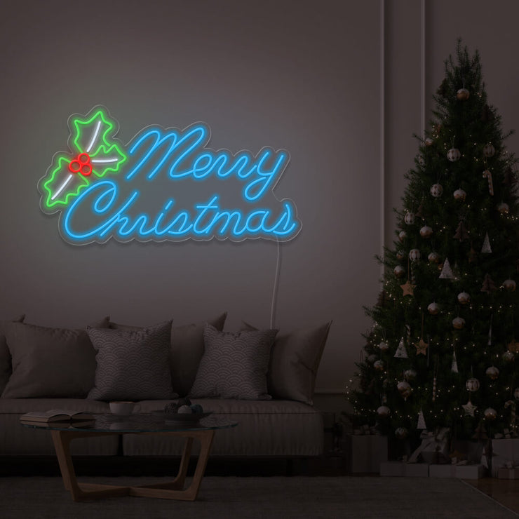 ice bue merry chirstmas mistletoe neon sign hanging above couch next to christmas tree