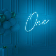 ice blue 1st birthday neon sign hanging on wall with balloons