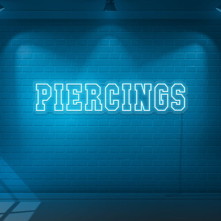 ice blue piercings neon sign hanging on wall