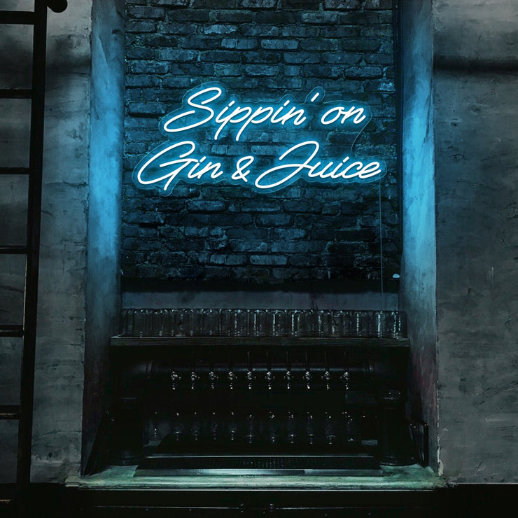 ice blue  sippin on gin and juice neon sign hanging on bar wall