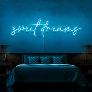 ice blue sweet dreams neon sign hanging on bedroom wall