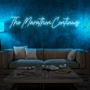 ice blue the marathon continues neon sign hanging on living room wall