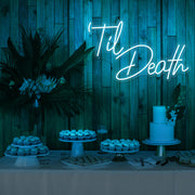 ice blue til death neon sign hanging on timber wall above dessert table