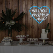 ice blue will you marry me heart neon sign hanging on timber wall above dessert table