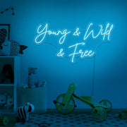 ice blue young wild and free neon sign hanging on kids bedroom wall