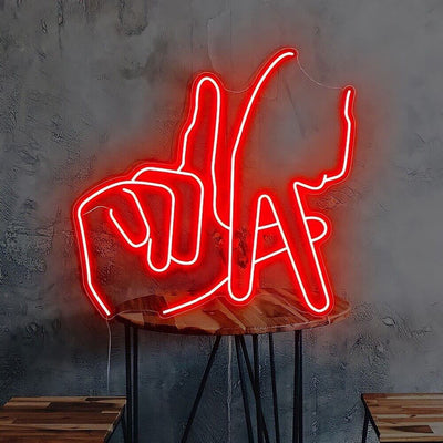 red LA fingers neon sign on table 