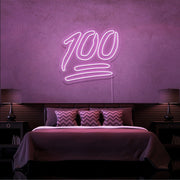 light pink 100 neon sign hanging on bedroom wall