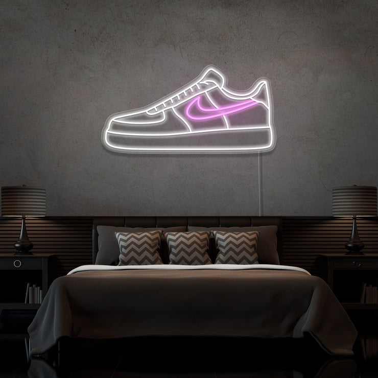 light pink air force 1 nike sneaker neon sign hanging on bedroom wall