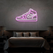 light pink air jordan 1 sneaker neon sign hanging on bedroom wall