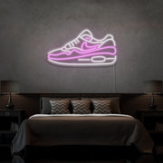 light pink air max 1 sneaker neon sign hanging on bedroom wall