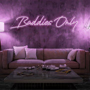 light pink baddies only neon sign hanging on living  room wall